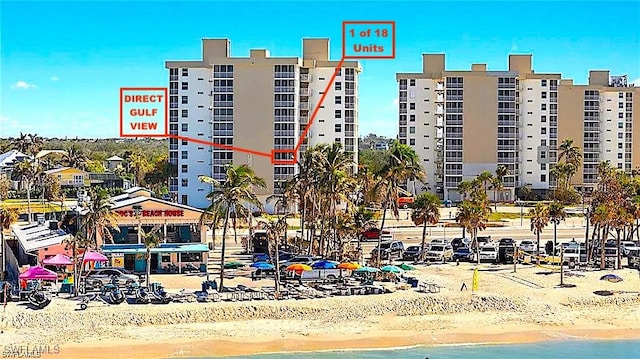 view of building exterior featuring a view of the beach and a water view