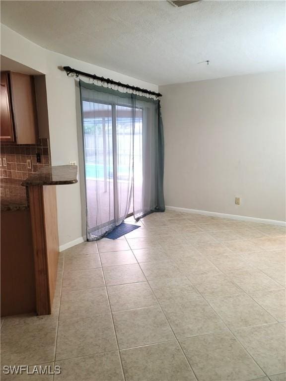 empty room with light tile patterned floors