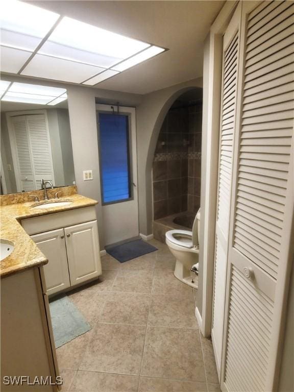 bathroom featuring tile patterned floors, vanity, and toilet