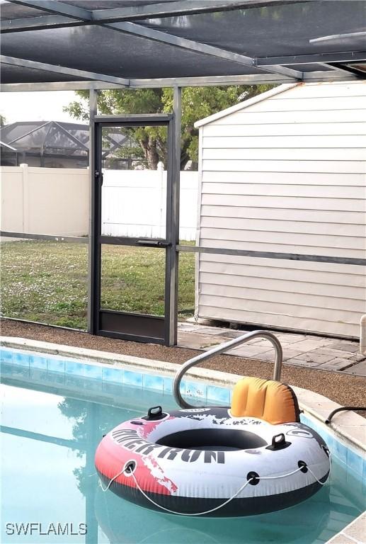 view of swimming pool with a lanai