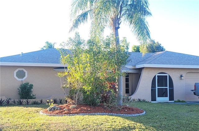 view of side of home with a yard and a garage