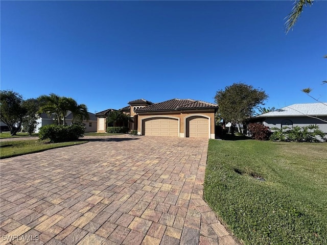 view of front of home featuring a garage and a front lawn