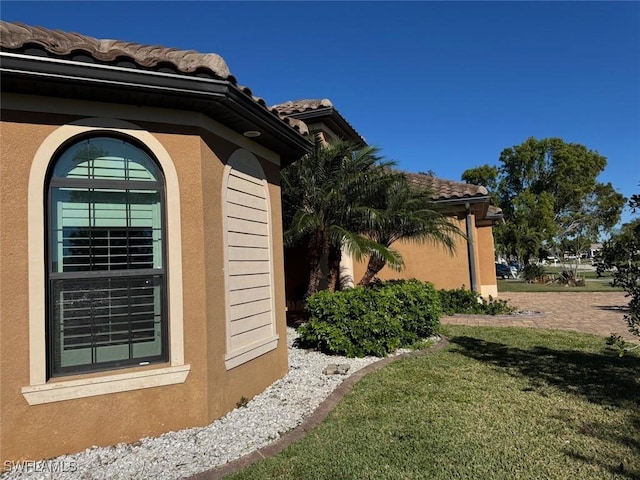 view of property exterior with a lawn