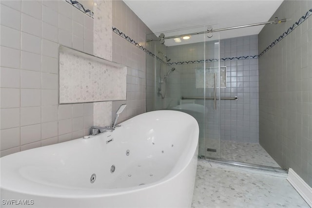 bathroom with shower with separate bathtub and tile walls