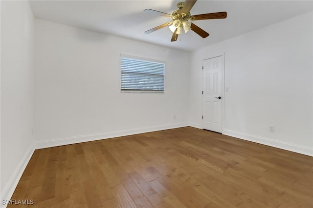 empty room with ceiling fan and wood-type flooring