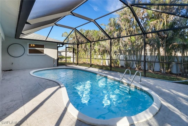 view of swimming pool featuring a patio and glass enclosure