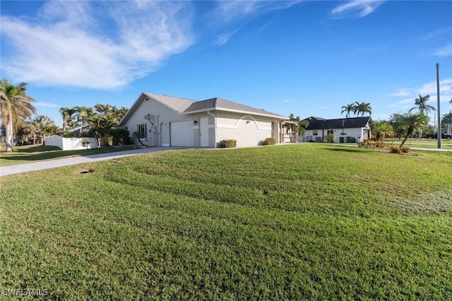 view of side of home featuring a garage and a lawn