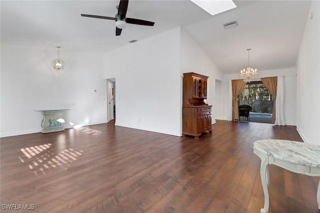 unfurnished living room with ceiling fan with notable chandelier, dark hardwood / wood-style flooring, and high vaulted ceiling