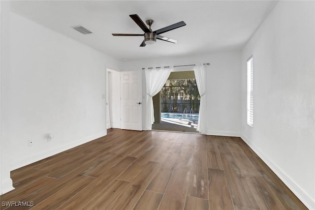 empty room featuring ceiling fan and dark hardwood / wood-style flooring