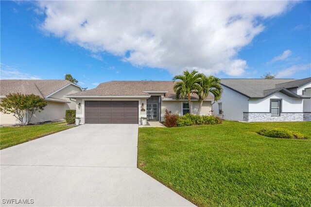 ranch-style house featuring a garage and a front lawn