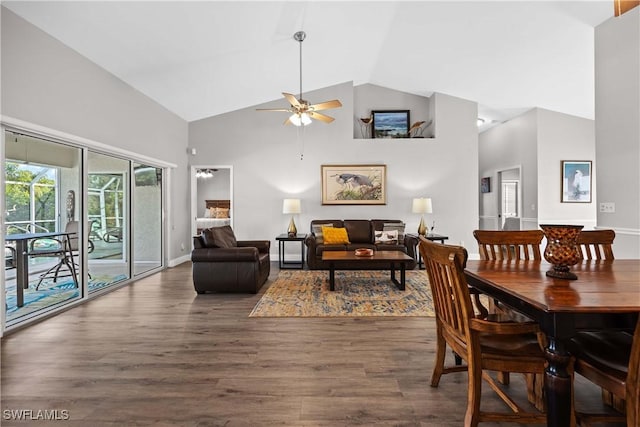 dining area featuring ceiling fan, dark wood-type flooring, and vaulted ceiling