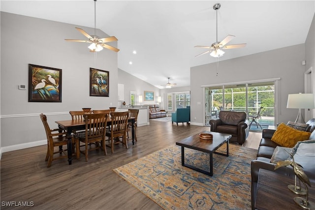 living room featuring dark hardwood / wood-style flooring, ceiling fan, plenty of natural light, and high vaulted ceiling