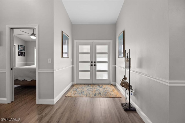 foyer entrance with french doors, a wealth of natural light, ceiling fan, and hardwood / wood-style floors