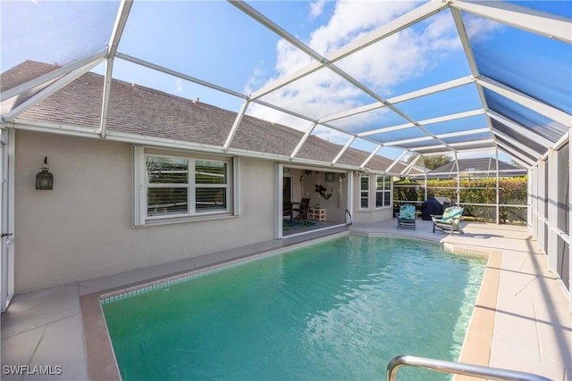 view of pool with a patio and a lanai