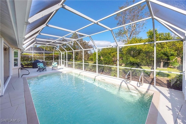 view of swimming pool featuring a lanai and a patio area