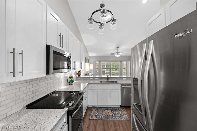 kitchen with sink, ceiling fan, decorative backsplash, white cabinetry, and stainless steel appliances