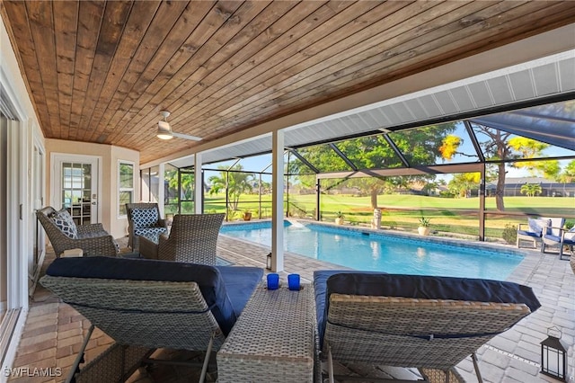 view of swimming pool featuring a lanai and a patio area