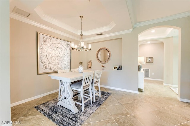 dining space featuring a chandelier, a tray ceiling, ornamental molding, and light tile patterned flooring