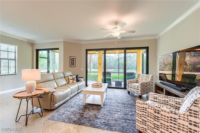 living room featuring ceiling fan, light tile patterned flooring, a healthy amount of sunlight, and crown molding