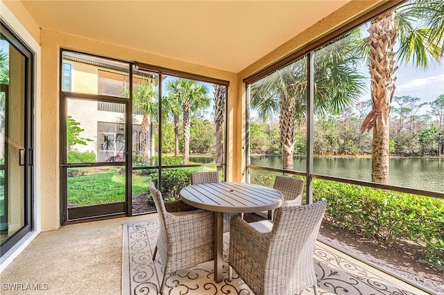 sunroom / solarium with a water view