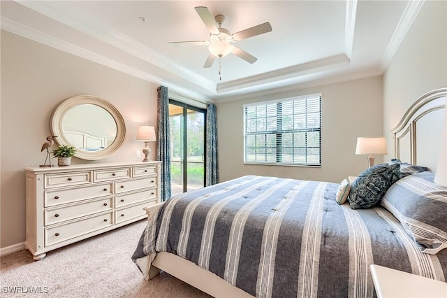 bedroom with access to exterior, light carpet, ornamental molding, a tray ceiling, and ceiling fan