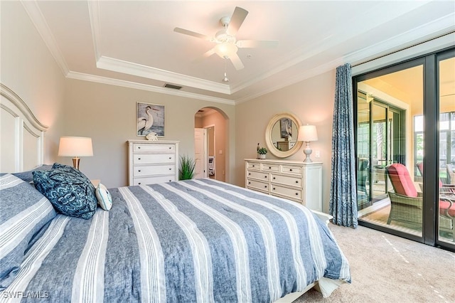 bedroom with access to exterior, ceiling fan, a raised ceiling, crown molding, and light carpet