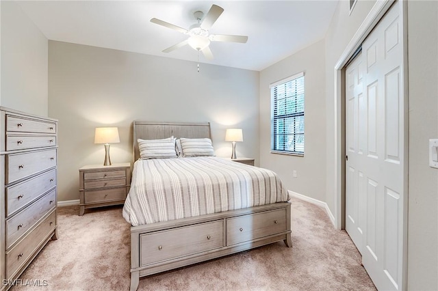 carpeted bedroom with a closet and ceiling fan