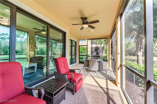 sunroom / solarium with plenty of natural light and ceiling fan