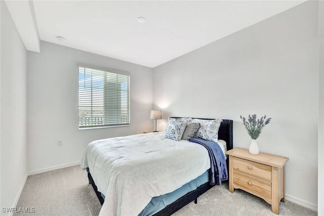 bedroom featuring light carpet