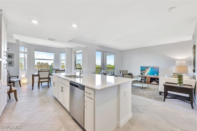 kitchen featuring dishwasher, an island with sink, white cabinets, and sink