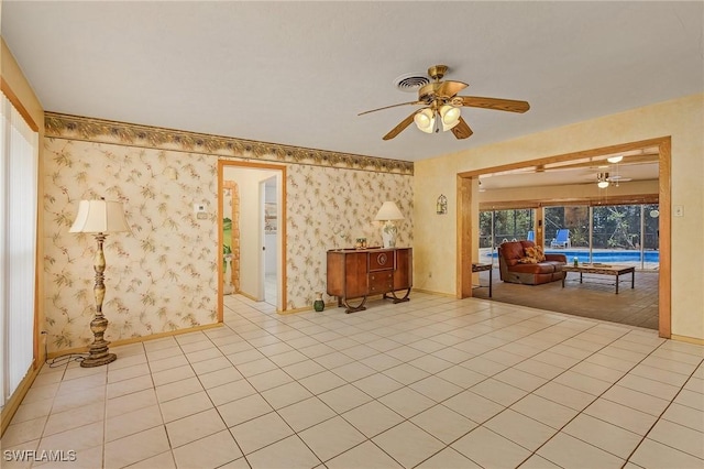 unfurnished living room with light tile patterned floors and ceiling fan