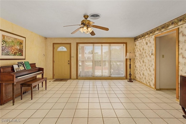 interior space featuring light tile patterned floors and ceiling fan