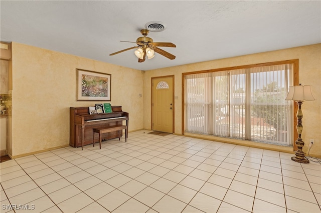 interior space featuring light tile patterned floors and ceiling fan