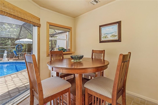 dining area featuring crown molding