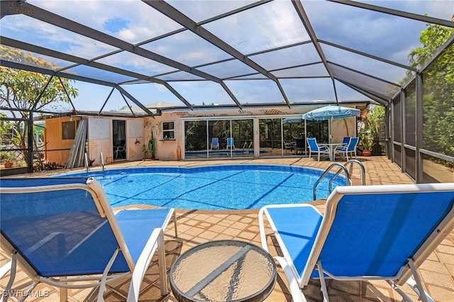 view of pool with a lanai and a patio area