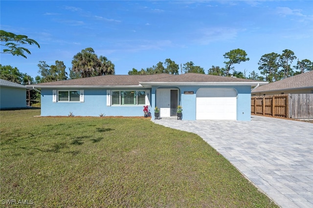 single story home featuring a garage and a front lawn