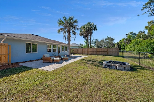 view of yard with a patio and an outdoor living space with a fire pit