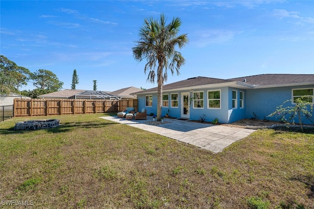 back of property featuring a lawn and a patio