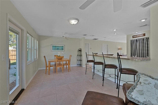 tiled dining area with ceiling fan