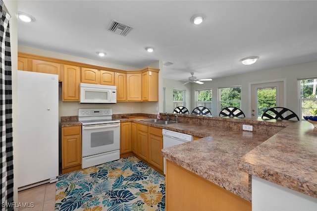 kitchen with white appliances, sink, kitchen peninsula, ceiling fan, and light tile patterned floors