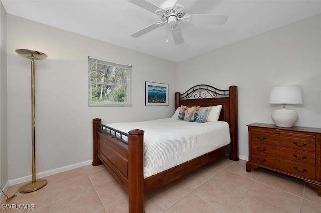 tiled bedroom featuring ceiling fan