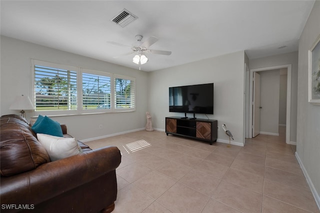 living room featuring ceiling fan, light tile patterned floors, and a healthy amount of sunlight