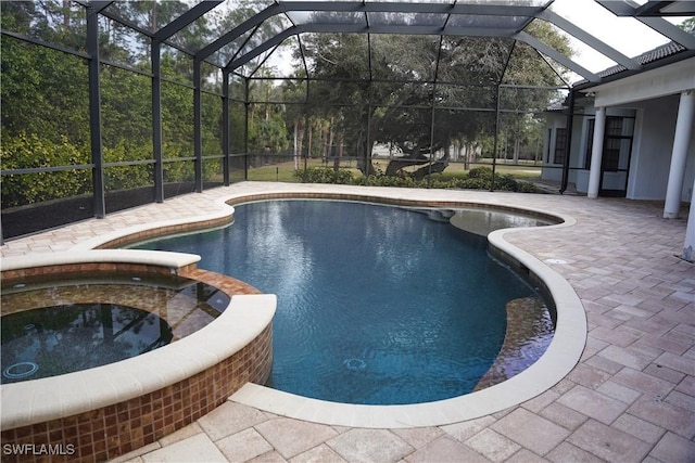 view of swimming pool featuring a lanai, an in ground hot tub, and a patio