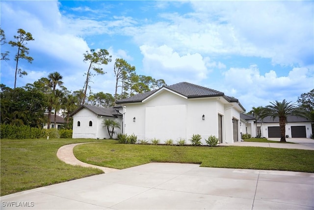 view of side of home featuring a garage and a yard