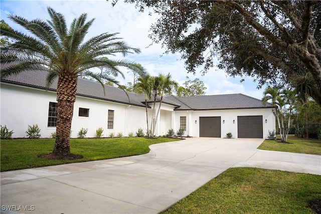 view of front of house featuring a front yard and a garage