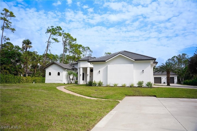 mediterranean / spanish home featuring a front lawn