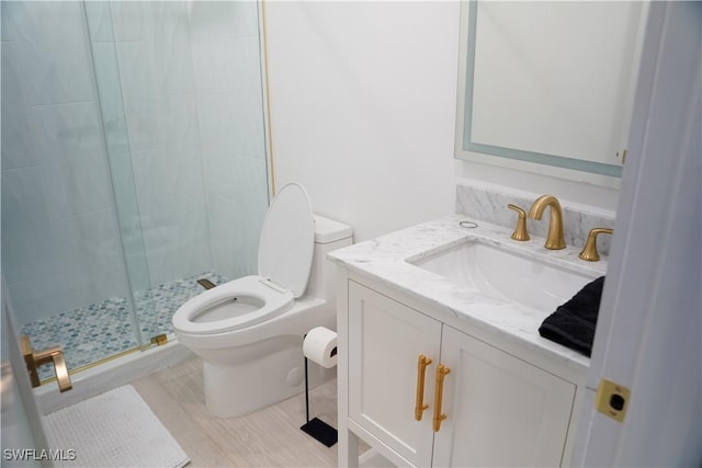 bathroom featuring walk in shower, vanity, and toilet