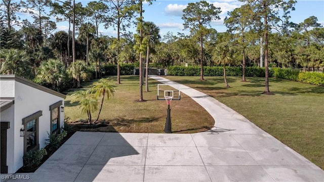 view of property's community with a yard and a patio area