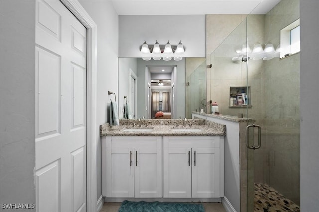 bathroom with vanity and a shower with shower door