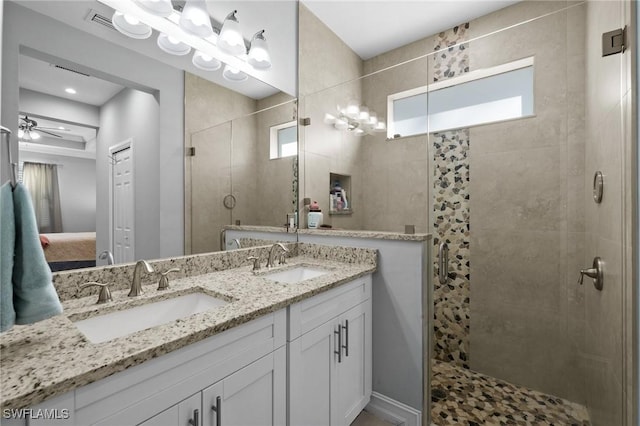 bathroom with vanity, ceiling fan, and a shower with shower door